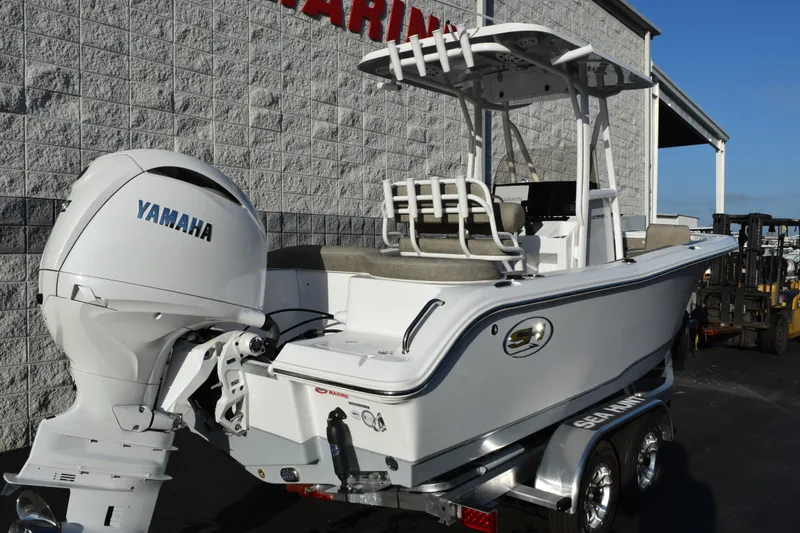 Slide: The Image of 2026 Sea Hunt Ultra 219 boat with Yamaha engine, parked on a trailer. - 4