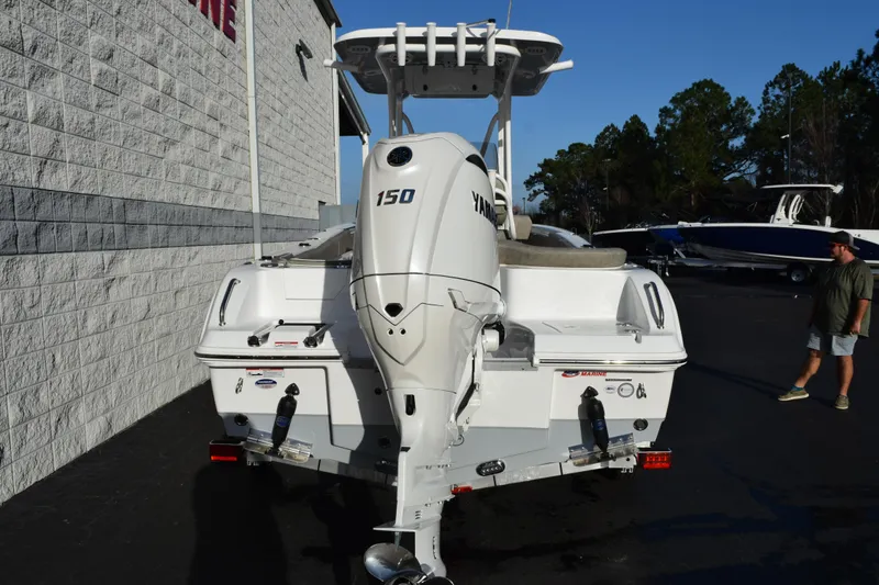 Slide: The Image of 2026 Sea Hunt Ultra 219 boat with Yamaha 150 engine, parked outdoors. - 5
