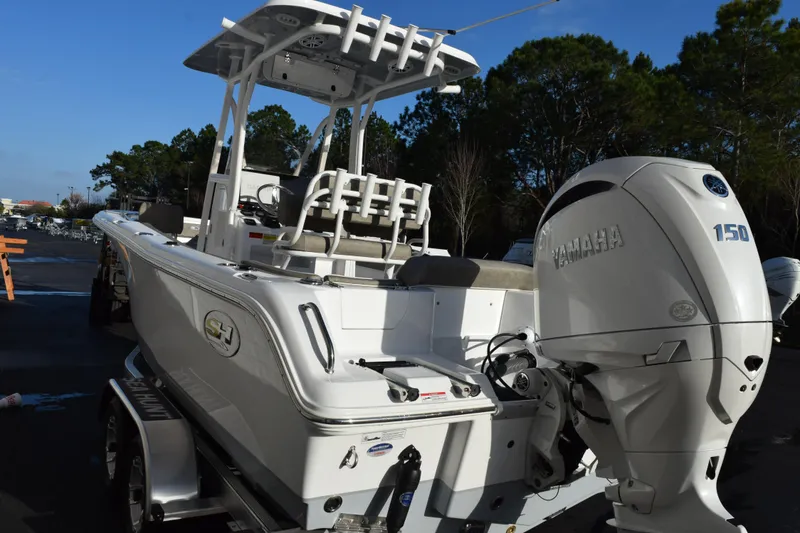 Slide: The Image of 2026 Sea Hunt Ultra 219 boat with Yamaha 150 engine, parked outdoors. - 6