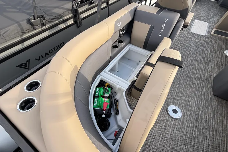 Slide: The Image of 2026 Viaggio Lago X24U boat interior with storage compartment and cup holders. - 12