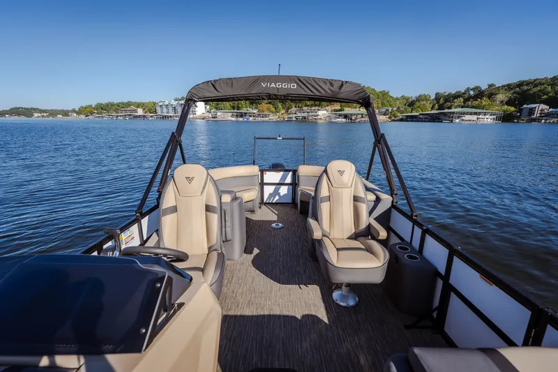 Slide: The Image of 2026 Viaggio Lago X24U pontoon boat on a serene lake with modern seating. - 32