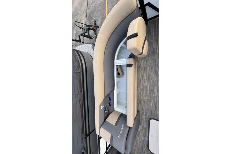 Slide: The Image of 2026 Viaggio Lago X24U boat interior with beige and gray seating, storage compartment open. - 26