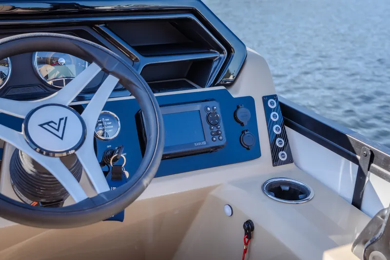 Slide: The Image of Steering console of 2026 Viaggio Lago X24U boat with modern controls and lake view. - 15