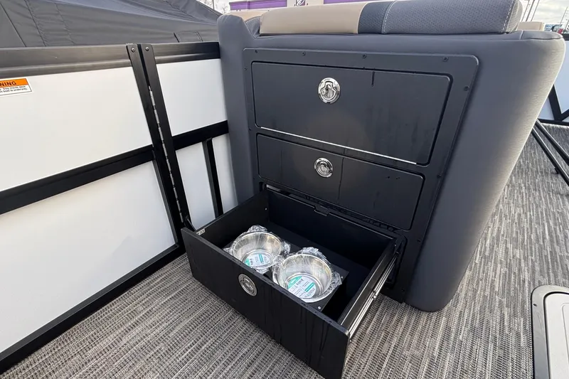 Slide: The Image of 2026 Viaggio Lago X24U boat interior with open storage drawer and packaged items. - 34