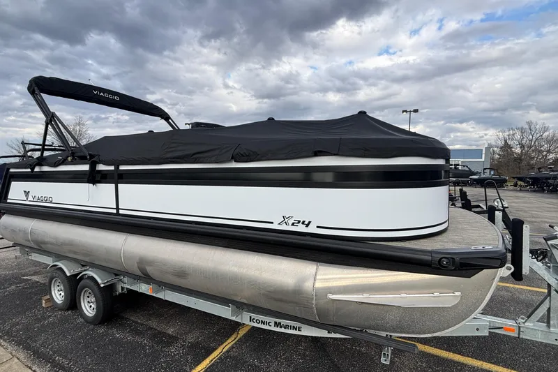 Slide: The Image of 2026 Viaggio Lago X24U pontoon boat on trailer under cloudy sky. - 38