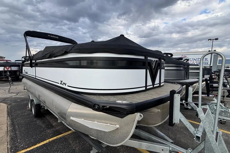 Slide: The Image of 2026 Viaggio Lago X24U pontoon boat on trailer under cloudy sky. - 39