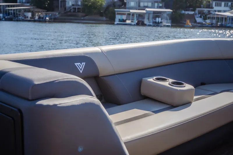 Slide: The Image of Luxurious seating on 2026 Viaggio Lago X24U boat with cup holders, overlooking serene waterfront. - 27