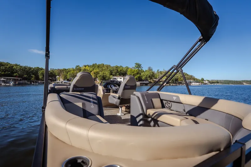 Slide: The Image of 2026 Viaggio Lago X24U pontoon boat on a serene lake with luxurious seating. - 10