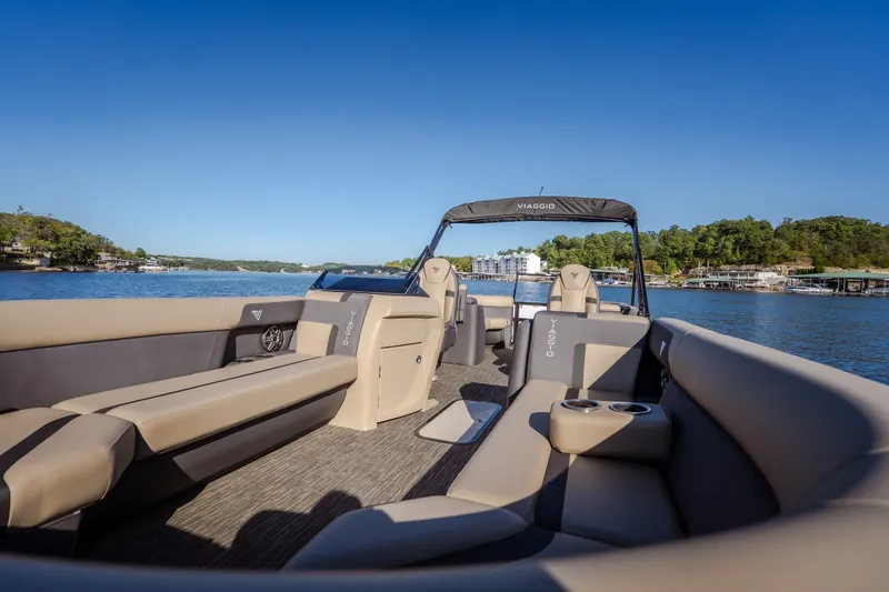 Slide: The Image of Luxurious 2026 Viaggio Lago X24U pontoon boat on a serene lake with plush seating. - 29