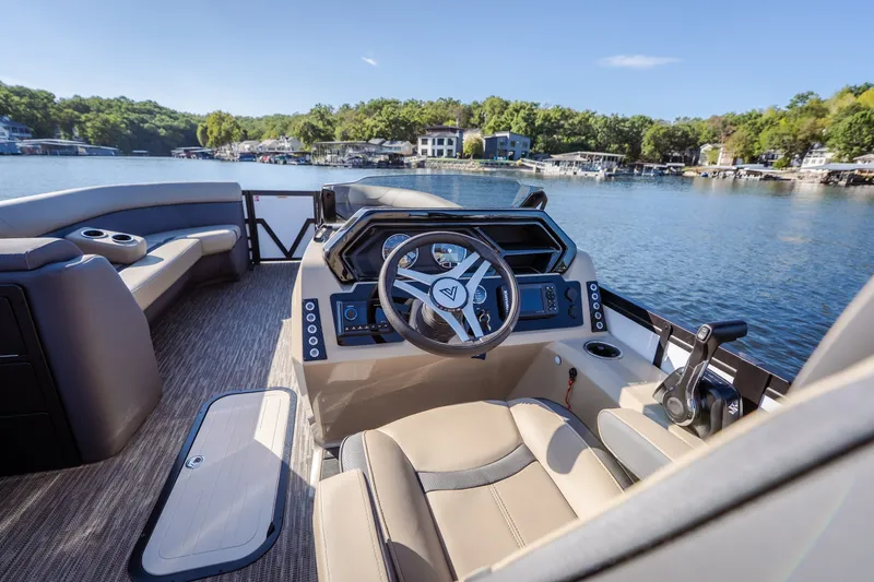 Slide: The Image of 2026 Viaggio Lago X24U boat interior with modern steering and seating on a scenic lake. - 14