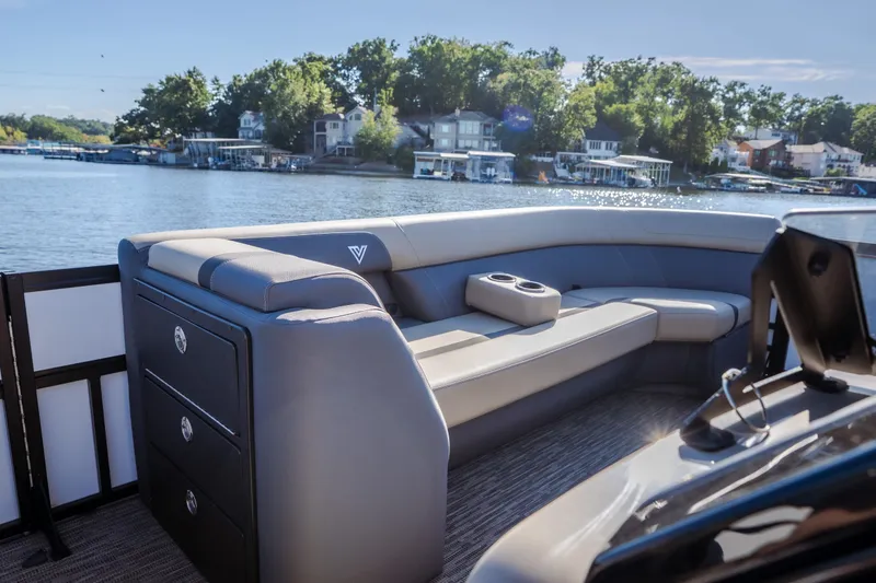 Slide: The Image of Luxurious 2026 Viaggio Lago X24U pontoon boat interior with plush seating on a serene lake. - 24