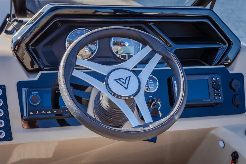 Slide: The Image of Steering wheel and dashboard of 2026 Viaggio Lago X24U boat. - 16