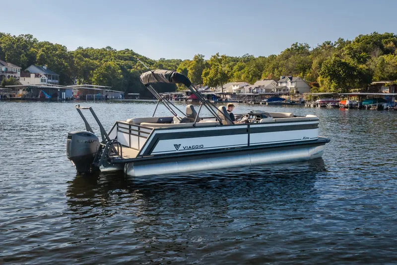 Slide: The Image of 2026 Viaggio Lago X24U pontoon boat on a scenic lake with lush greenery. - 3