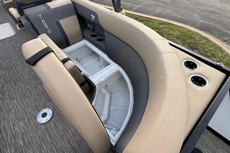 Slide: The Image of Viaggio Lago X24U 2026 boat interior with beige and gray seating, cup holders, and storage compartment. - 9