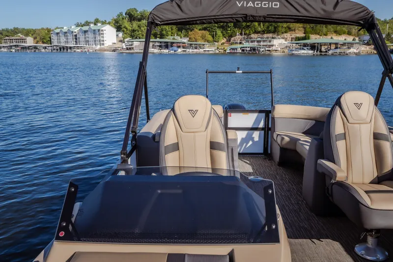 Slide: The Image of 2026 Viaggio Lago X24U pontoon boat on a serene lake with modern seating. - 33