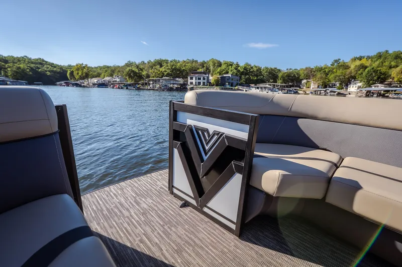 Slide: The Image of 2026 Viaggio Lago X24U pontoon boat interior with plush seating on a scenic lake. - 25