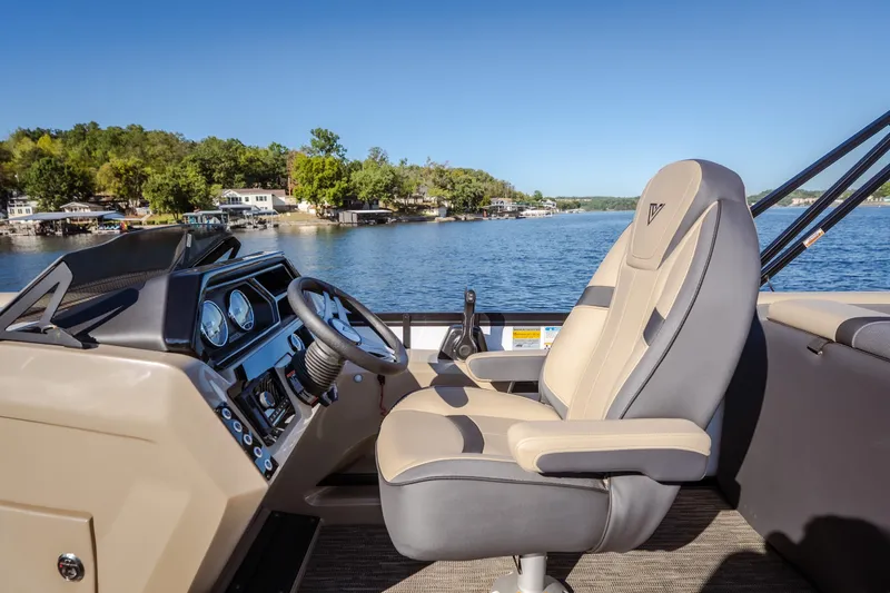 Slide: The Image of Captain's seat and dashboard of 2026 Viaggio Lago X24U boat on a scenic lake. - 13