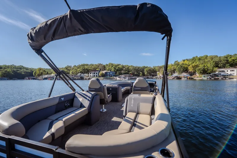 Slide: The Image of 2026 Viaggio Lago X24U pontoon boat on a serene lake with lush shoreline. - 39