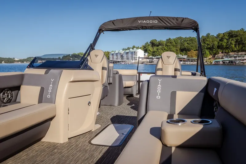 Slide: The Image of 2026 Viaggio Lago X24U pontoon boat interior with luxurious seating on a scenic lake. - 30