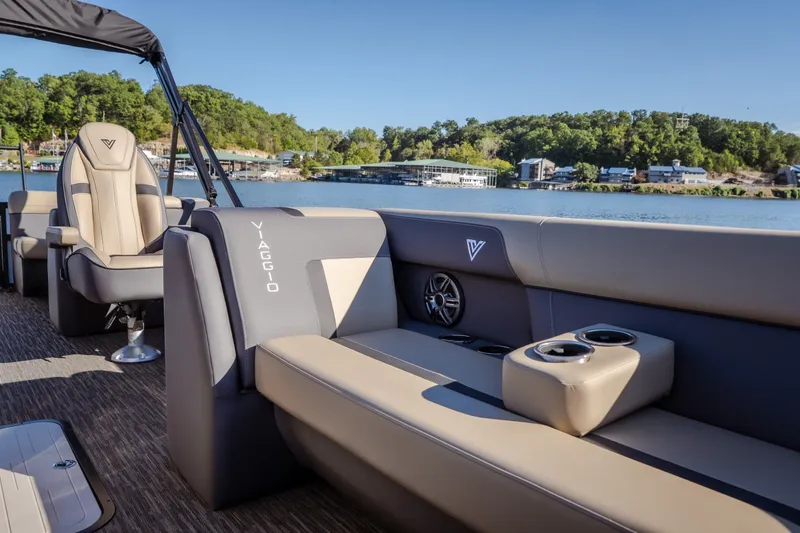 Slide: The Image of 2026 Viaggio Lago X24U pontoon boat interior with luxurious seating on a scenic lake. - 31