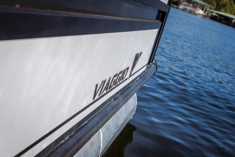 Slide: The Image of 2026 Viaggio Lago X24U boat on water, showcasing sleek design and branding. - 41