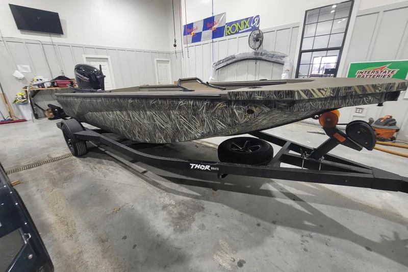 The Image of 2026 Thor 1860 Timber Hammer Elite boat on trailer in garage setting. - 1