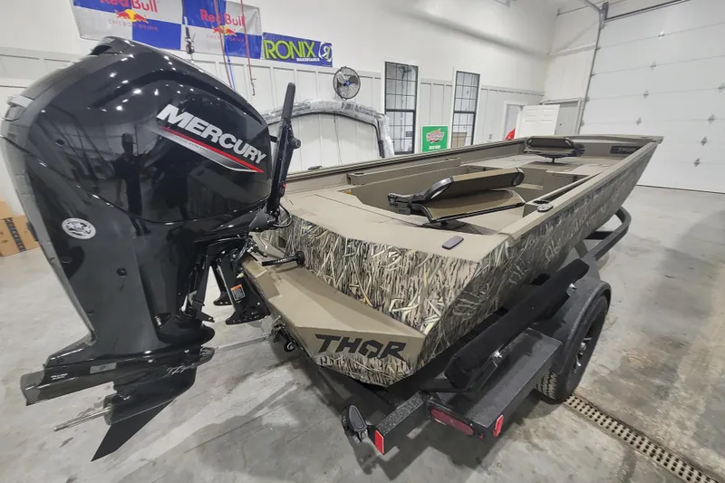 Slide: The Image of 2026 Thor 1860 Timber Hammer Elite boat with Mercury engine in a garage setting. - 10