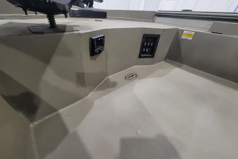 Slide: The Image of 2026 Thor 1860 Timber Hammer Elite boat interior with control panel and logo. - 12