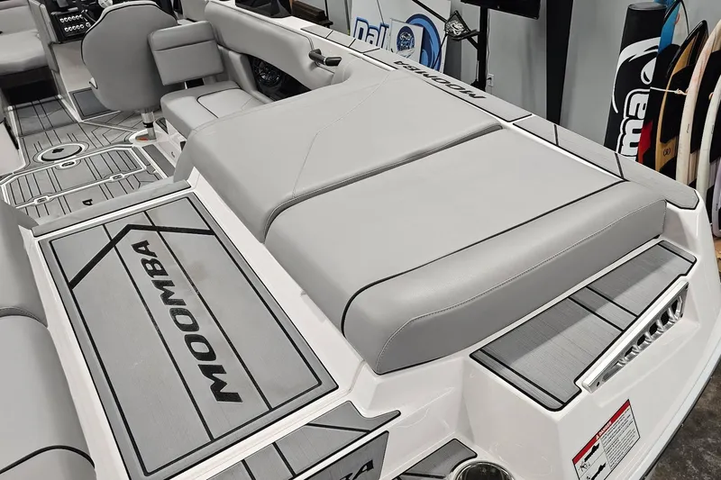 Slide: The Image of 2024 Moomba Mojo boat interior with gray seating and branded flooring. - 10