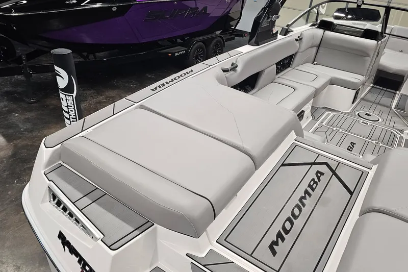 Slide: The Image of 2024 Moomba Mojo boat interior with gray seating and branded flooring. - 11