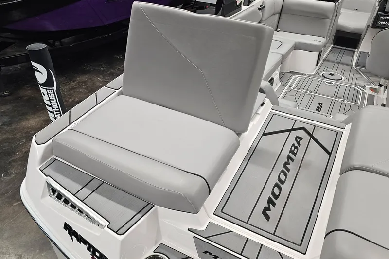 Slide: The Image of 2024 Moomba Mojo boat interior with gray seating and branded flooring. - 13