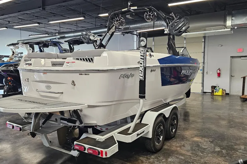 Slide: The Image of 2024 Moomba Mojo boat on trailer in showroom, rear view. - 6
