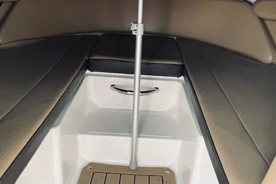 Slide: The Image of Interior view of 2019 Sea Ray SPX 210 boat, featuring seating and storage area. - 10