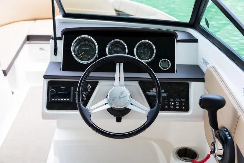 Slide: The Image of Manufacturer Provided Image: 2019 Sea Ray SPX 210 boat dashboard with steering wheel and control panel. - 13