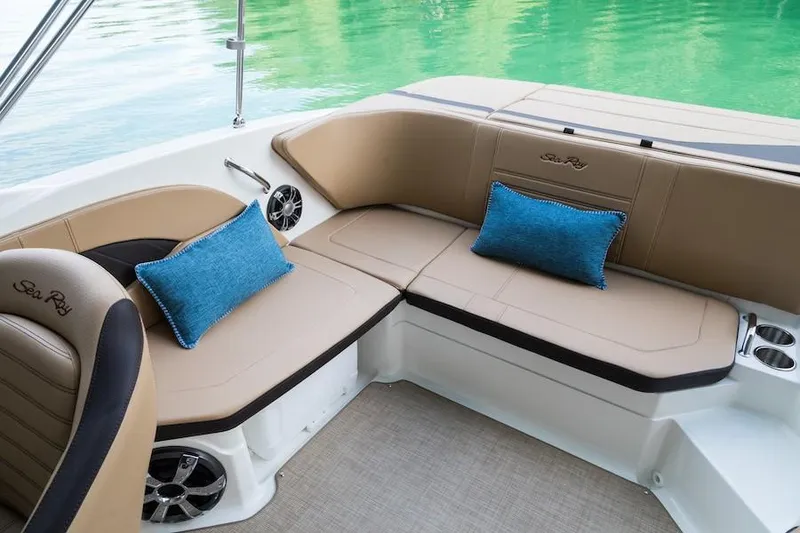 Slide: The Image of Manufacturer Provided Image: 2019 Sea Ray SPX 210 boat interior with tan seating and blue cushions. - 17