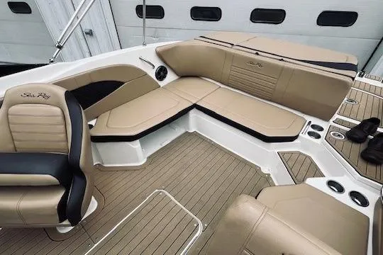 Slide: The Image of 2019 Sea Ray SPX 210 boat interior with tan seating and sleek design. - 6