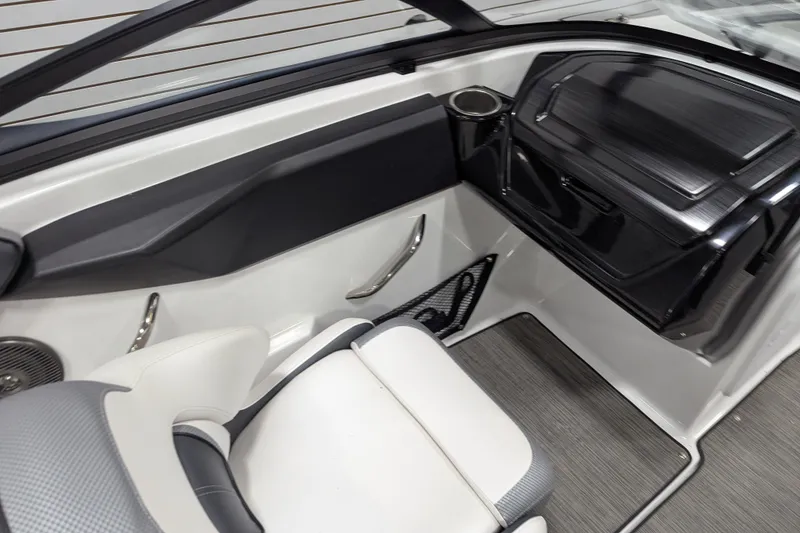 Slide: The Image of Interior of 2023 Scarab 195 ID boat, featuring sleek seating and modern dashboard design. - 12