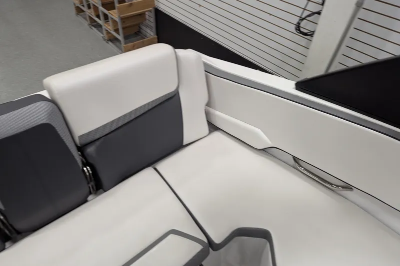 Slide: The Image of Interior seating of 2023 Scarab 195 ID boat, featuring sleek white and gray upholstery. - 14