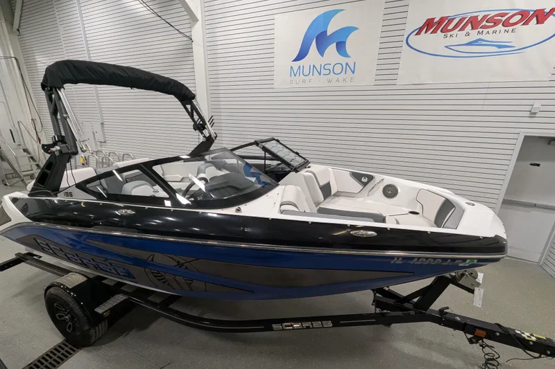 Slide: The Image of 2023 Scarab 195 ID boat in showroom, featuring sleek design and modern interior. - 2