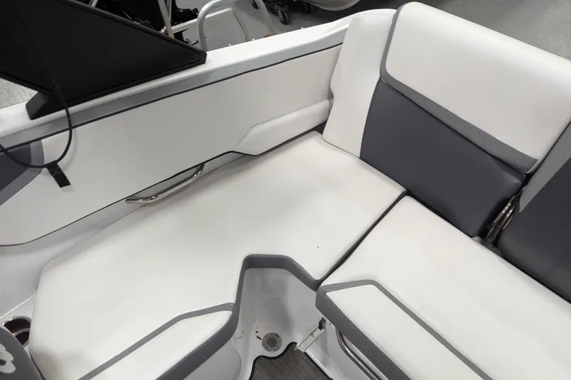 Slide: The Image of 2023 Scarab 195 ID boat interior with white and gray seating. - 8