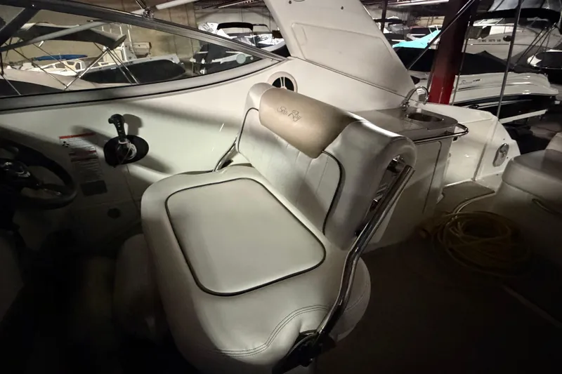 Slide: The Image of 2009 Sea Ray 270 Sundancer interior with helm seat and cockpit details. - 11
