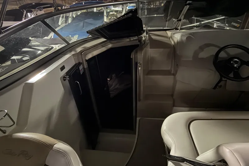 Slide: The Image of 2009 Sea Ray 270 Sundancer interior with helm and cabin entrance. - 12