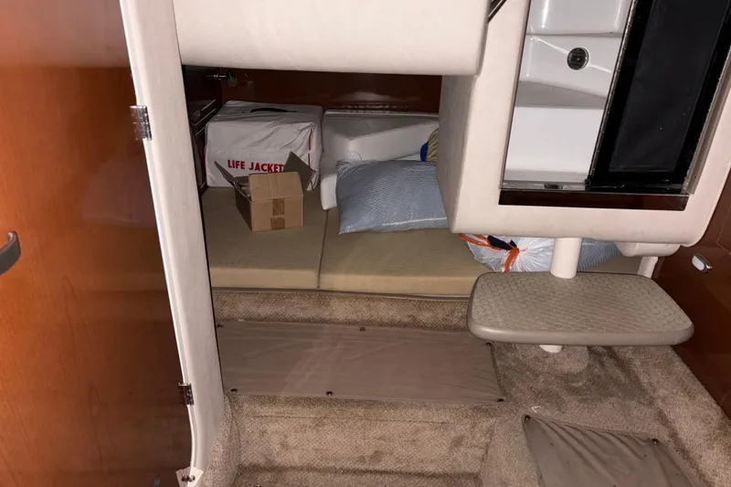 Slide: The Image of 2009 Sea Ray 270 Sundancer cabin interior with life jackets and storage. - 14