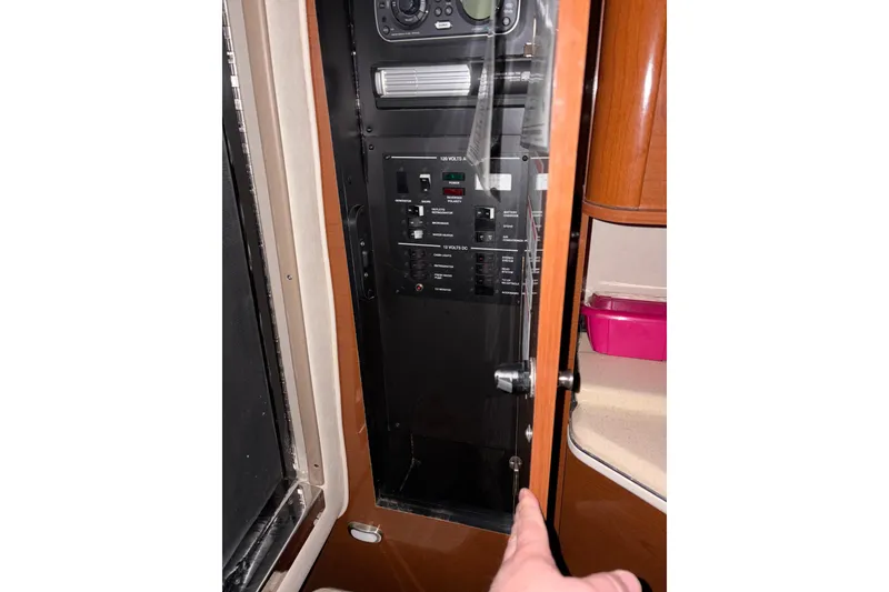 Slide: The Image of Electrical panel inside 2009 Sea Ray 270 Sundancer boat cabin, showing controls and switches. - 15