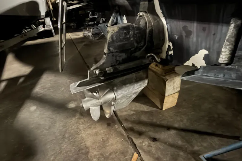 Slide: The Image of 2009 Sea Ray 270 Sundancer boat propeller and drive system in a garage setting. - 17