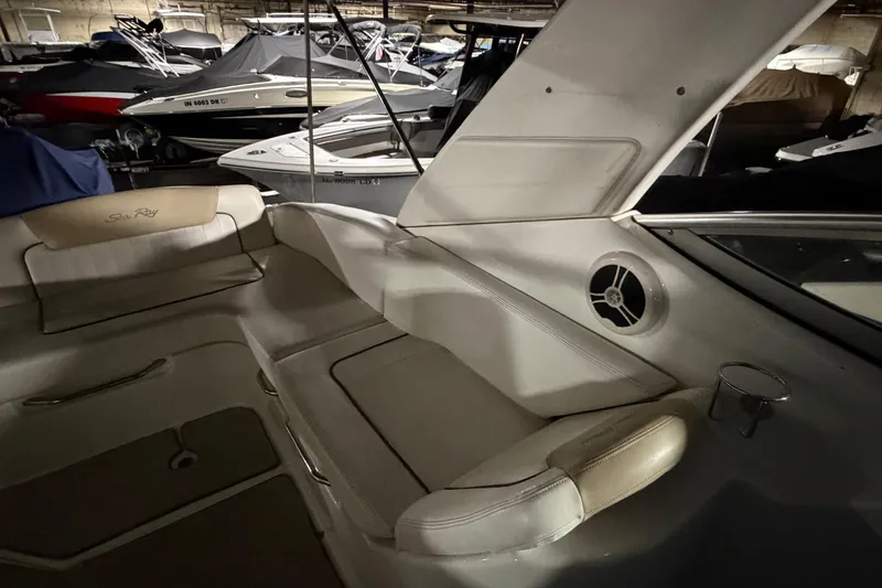 Slide: The Image of 2009 Sea Ray 270 Sundancer interior with cushioned seating and cup holder. - 20