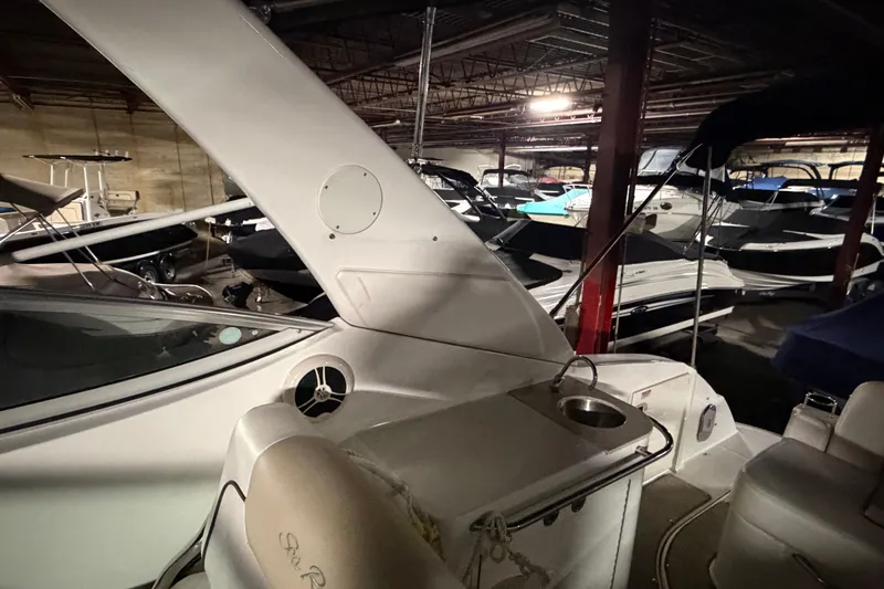 Slide: The Image of 2009 Sea Ray 270 Sundancer in indoor storage, surrounded by other boats. - 21