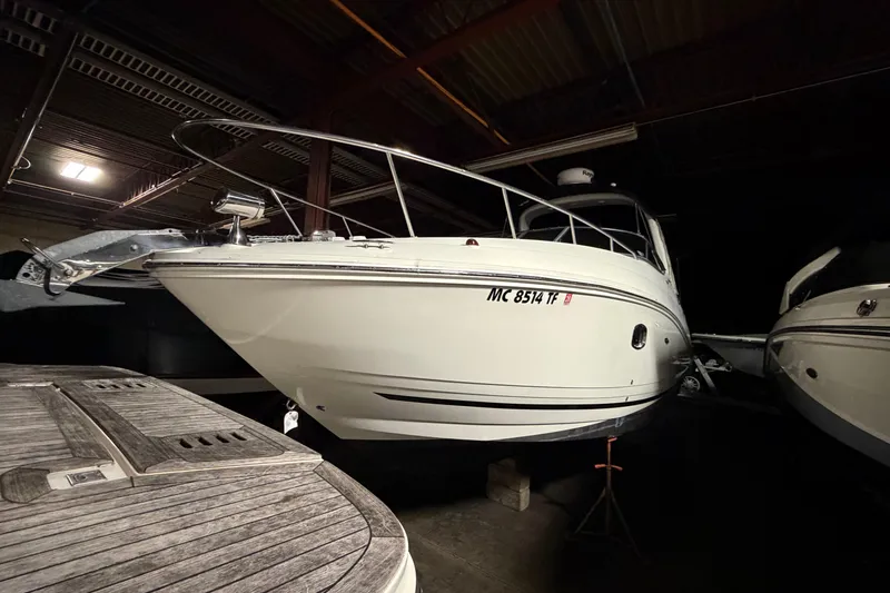 Slide: The Image of 2009 Sea Ray 270 Sundancer boat in indoor storage, side view. - 5