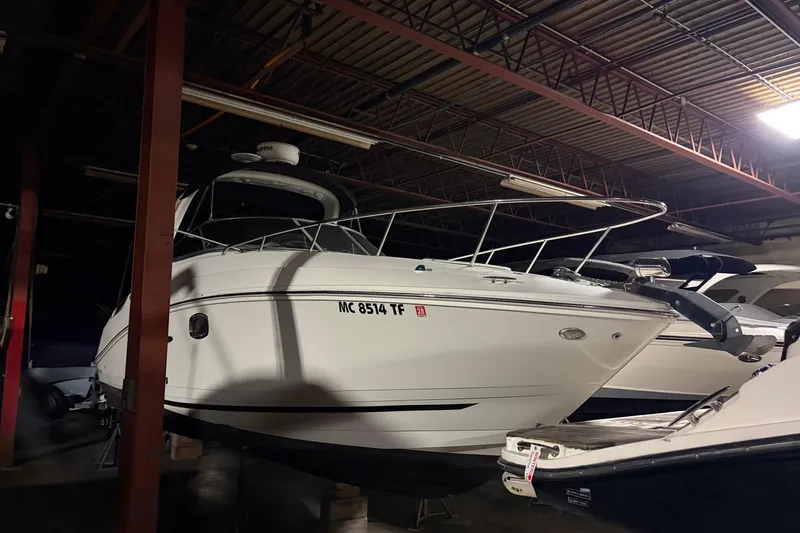 Slide: The Image of 2009 Sea Ray 270 Sundancer boat stored indoors, side view. - 6