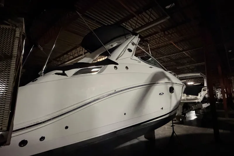 Slide: The Image of 2009 Sea Ray 270 Sundancer boat in indoor storage, side view. - 9